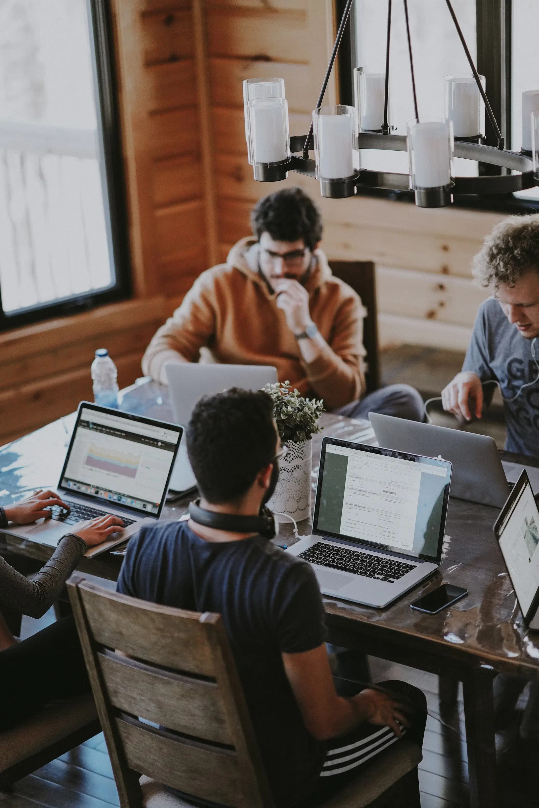 Diverse team of experienced technology professionals collaborating on innovative business solutions in a modern collaborative workspace
