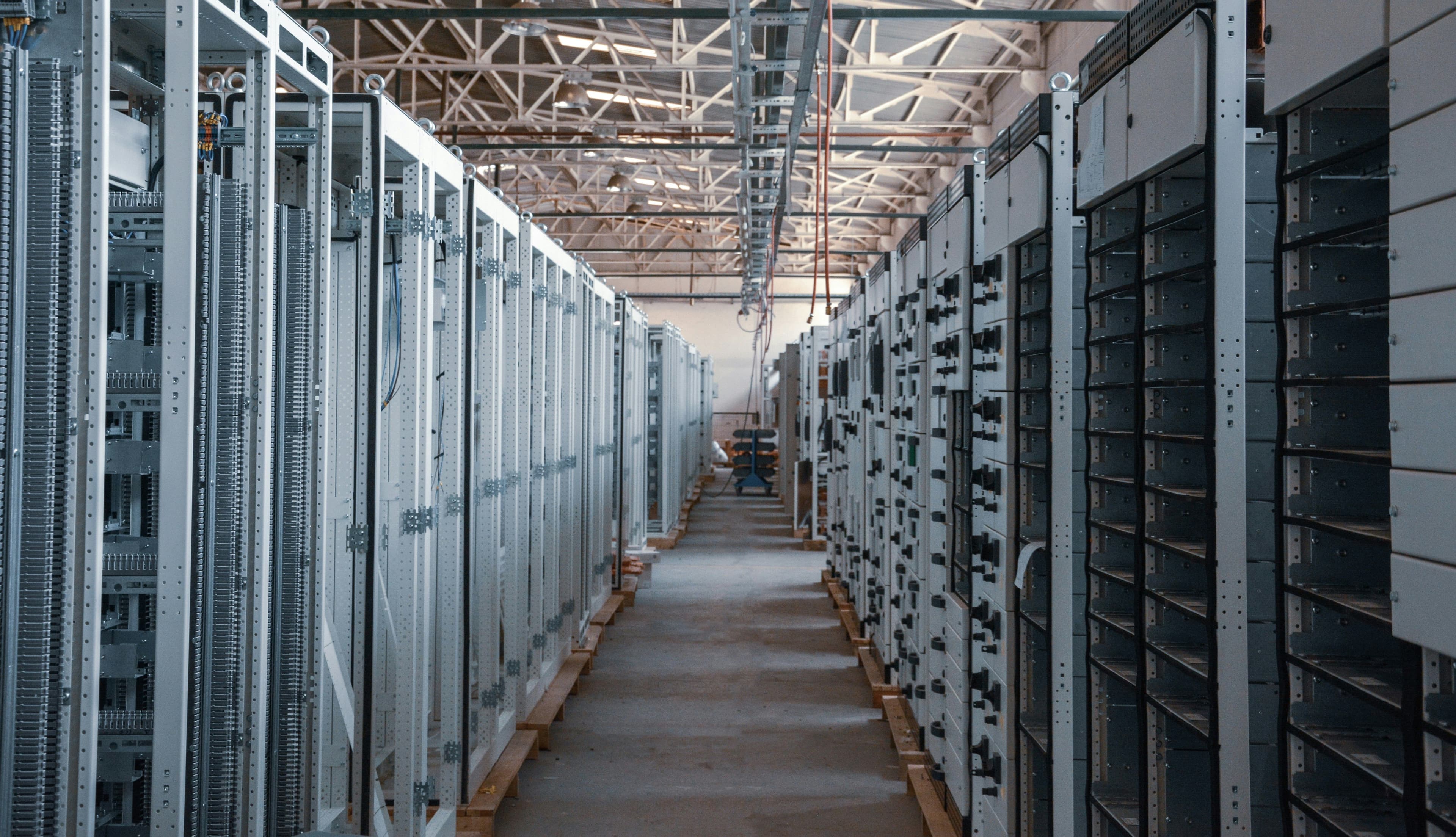 An image of a data center alley with several computers during daylight