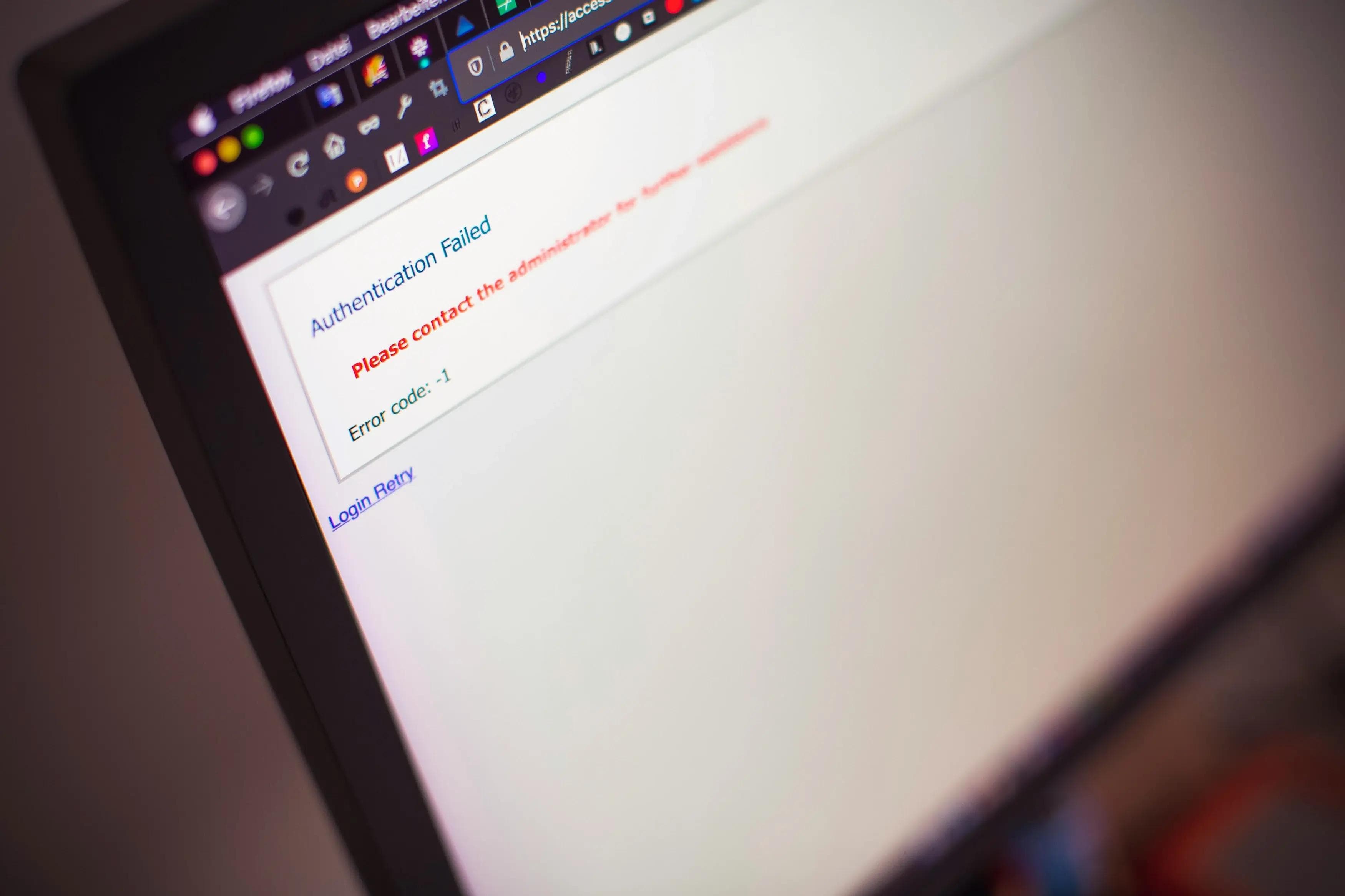 Close-up of a computer screen displaying an 'Authentication Failed' error message with instructions to contact the administrator and an error code -1.